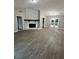 A spacious living room featuring a stone fireplace, modern lighting, and stylish flooring at 168 Park Ln, Dallas, GA 30157