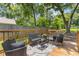 Cozy backyard deck surrounded by mature trees with outdoor seating perfect for entertaining at 2728 Mcafee Rd, Decatur, GA 30032