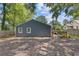 Wide backyard of home with dark gray siding and white trim, surrounded by trees and new stone paver walkway at 2728 Mcafee Rd, Decatur, GA 30032