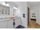 Bright bathroom with double sinks, granite countertop, framed mirrors and linen closet at 2728 Mcafee Rd, Decatur, GA 30032