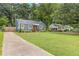 Blue home with a spacious front yard and a long driveway leading up to the residence at 2728 Mcafee Rd, Decatur, GA 30032
