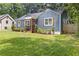 Quaint blue home featuring neat landscaping, wooden shutters, and a covered porch entry at 2728 Mcafee Rd, Decatur, GA 30032