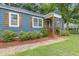 Close-up of the home's entry with updated landscaping, shutters, and covered porch at 2728 Mcafee Rd, Decatur, GA 30032