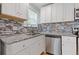 Updated kitchen boasts stainless steel appliances, granite countertops and tile backsplash at 2728 Mcafee Rd, Decatur, GA 30032