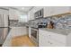 Modern kitchen features granite countertops and stainless steel appliances at 2728 Mcafee Rd, Decatur, GA 30032