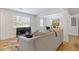 Bright living room with hardwood floors, neutral decor, and seamless integration to the dining area at 2728 Mcafee Rd, Decatur, GA 30032
