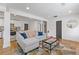 Open-concept living room with a comfortable sofa, adjacent to a modern kitchen and dining space at 2728 Mcafee Rd, Decatur, GA 30032