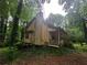 Exterior showcasing a charming home with a porch, wooden siding, and a natural wooded setting at 33 Powder Dr, Dallas, GA 30157