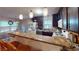 Kitchen with breakfast bar, dark cabinets, modern appliances, and eat-in dining area at 33 Powder Dr, Dallas, GA 30157