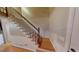 A staircase with wooden stairs and white risers at 33 Powder Dr, Dallas, GA 30157