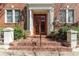 Inviting entryway featuring brick steps, white pillars, and a bright red front door at 733 Frederica Ne St # 7, Atlanta, GA 30306