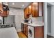Modern kitchen featuring a washer/dryer combo, stainless steel appliances, and painted brick accent wall at 733 Frederica Ne St # 7, Atlanta, GA 30306