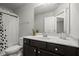 Bathroom with a vanity, decorated mirror and shower with patterned curtain at 804 Whittington Sw Pkwy, Marietta, GA 30060
