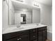 Modern bathroom with double sinks, dark cabinets, and a large mirror at 804 Whittington Sw Pkwy, Marietta, GA 30060