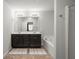 Modern bathroom with double vanity, dark wood cabinets, soaking tub, and neutral color scheme at 804 Whittington Sw Pkwy, Marietta, GA 30060