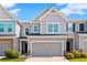 Charming townhome featuring a large garage, neutral siding, and manicured landscaping at 804 Whittington Sw Pkwy, Marietta, GA 30060