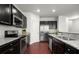 Modern kitchen with granite countertops, stainless steel appliances, and dark cabinetry at 804 Whittington Sw Pkwy, Marietta, GA 30060