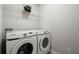 Functional laundry room equipped with front-load washer and dryer, plus storage shelf at 804 Whittington Sw Pkwy, Marietta, GA 30060