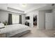 Spacious bedroom with tray ceiling, large window, walk-in closet, and neutral color palette at 804 Whittington Sw Pkwy, Marietta, GA 30060