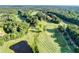 Aerial view of well-manicured golf course with lush greenery, sand traps and a pond at 1635 Lake Heights Cir, Dacula, GA 30019