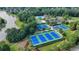 Aerial view showcasing community amenities: tennis courts, pool, and scenic lake at 1635 Lake Heights Cir, Dacula, GA 30019