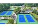 Aerial view of community tennis courts surrounded by trees and lush landscaping at 1635 Lake Heights Cir, Dacula, GA 30019