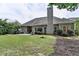 Backyard features green grass, a patio area, and mature landscaping at 1635 Lake Heights Cir, Dacula, GA 30019