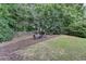 Private backyard featuring a cozy fire pit area perfect for outdoor relaxation and entertaining guests at 1635 Lake Heights Cir, Dacula, GA 30019