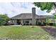 Expansive backyard with a lawn, mature trees, outdoor seating, and games at 1635 Lake Heights Cir, Dacula, GA 30019