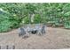 Landscaped backyard with an outdoor seating area surrounding a fire pit at 1635 Lake Heights Cir, Dacula, GA 30019