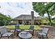 Well-maintained backyard with lush greenery, patio furniture, and mature trees at 1635 Lake Heights Cir, Dacula, GA 30019