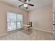 Well-lit bedroom featuring neutral walls, plush carpet, and a bright window at 1635 Lake Heights Cir, Dacula, GA 30019