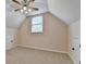 Spacious bonus room features plush carpet, neutral walls, and access to attic storage at 1635 Lake Heights Cir, Dacula, GA 30019
