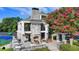 Elegant clubhouse featuring an outdoor fireplace, seating, and lush landscaping, ideal for community gatherings at 1635 Lake Heights Cir, Dacula, GA 30019
