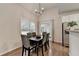 Bright dining area features hardwood floors, neutral walls, a window, and modern lighting at 1635 Lake Heights Cir, Dacula, GA 30019