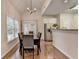 Bright dining area with hardwood floors, a view of the patio, and a stainless steel refrigerator at 1635 Lake Heights Cir, Dacula, GA 30019