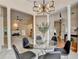 Dining area with a modern glass table, statement chandelier, and open-concept layout at 1635 Lake Heights Cir, Dacula, GA 30019