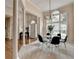 Elegant dining area with a modern chandelier, large windows, and classic columns at 1635 Lake Heights Cir, Dacula, GA 30019