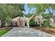 Charming brick home featuring mature trees, manicured landscaping, and a long driveway at 1635 Lake Heights Cir, Dacula, GA 30019