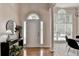 Foyer with wood floors, tall windows, decorative lamps and flowers at 1635 Lake Heights Cir, Dacula, GA 30019