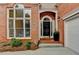 Charming brick home featuring a well-manicured landscape and front door at 1635 Lake Heights Cir, Dacula, GA 30019