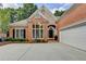 Beautiful brick home with manicured landscaping, a side-entry garage, and a welcoming entrance at 1635 Lake Heights Cir, Dacula, GA 30019