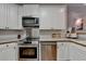 Modern kitchen with stainless steel appliances, white cabinets, and plenty of counter space at 1635 Lake Heights Cir, Dacula, GA 30019