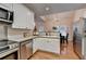 Well-lit kitchen with stainless steel appliances, wooden floors, and an open layout at 1635 Lake Heights Cir, Dacula, GA 30019