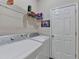 Laundry room with washer, dryer, wire shelving, and door to storage at 1635 Lake Heights Cir, Dacula, GA 30019