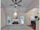 Bright living room featuring a fireplace, large windows, and open to the dining area at 1635 Lake Heights Cir, Dacula, GA 30019