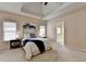 Spacious main bedroom with plush carpet, ample windows, tray ceiling and ensuite bathroom at 1635 Lake Heights Cir, Dacula, GA 30019