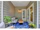 Charming outdoor patio with seating, plants, and access to the home's interior at 1635 Lake Heights Cir, Dacula, GA 30019