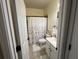 A clean bathroom featuring a shower with a patterned curtain, and a neutral color palette at 223 Sterling Brook Ln, Canton, GA 30114