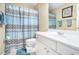 Bathroom with vanity, toilet, and shower with patterned blue shower curtain at 223 Sterling Brook Ln, Canton, GA 30114